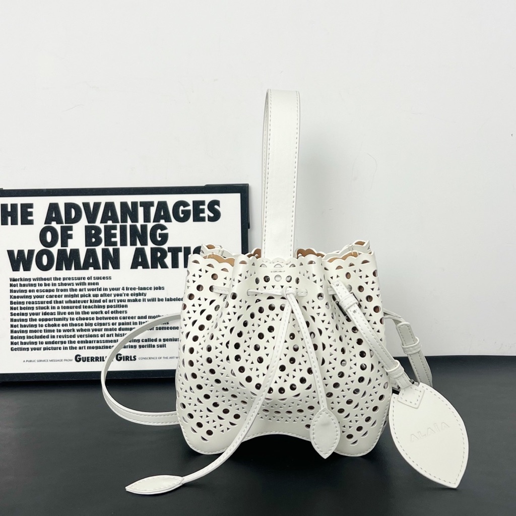 Alaia White Laser-Cut Drawstring Bucket Bag